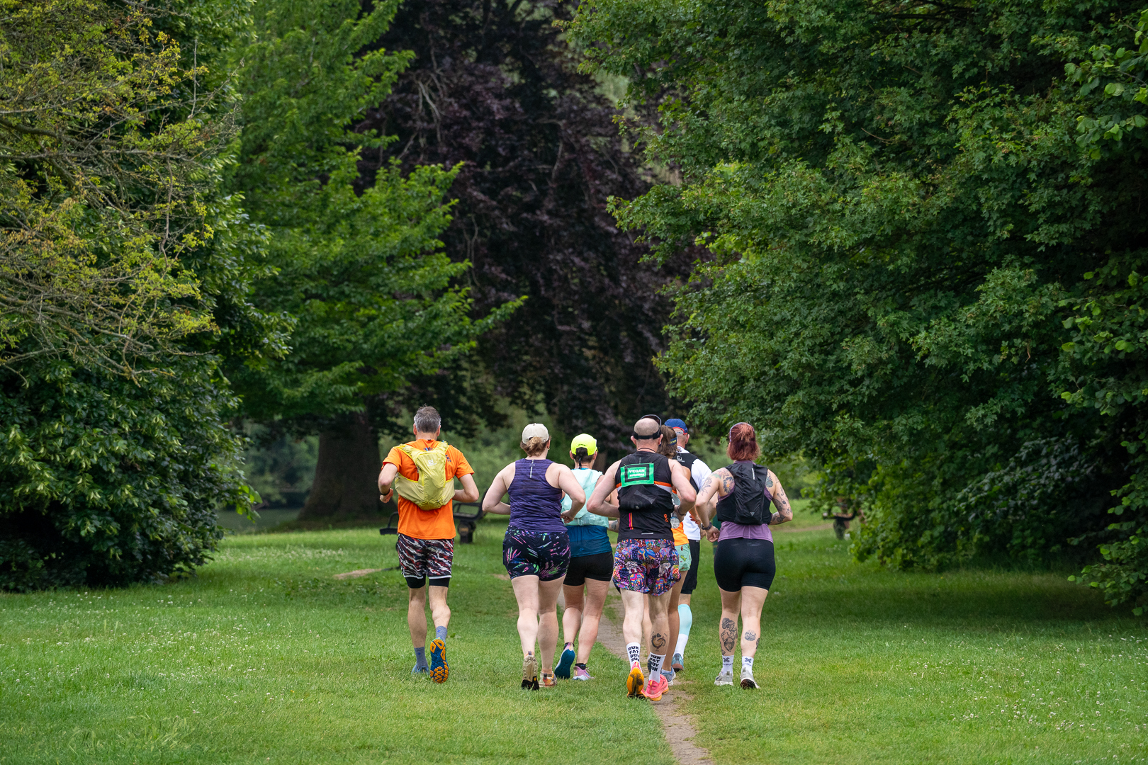 A group running together along a parkland path