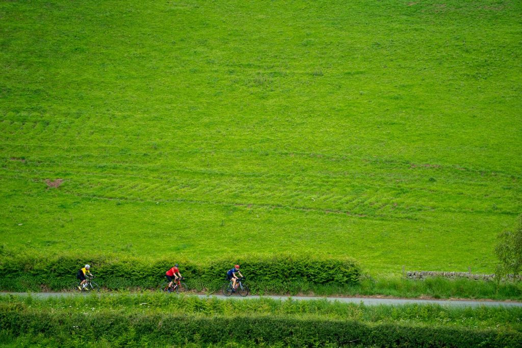 Riders small against open English farmland
